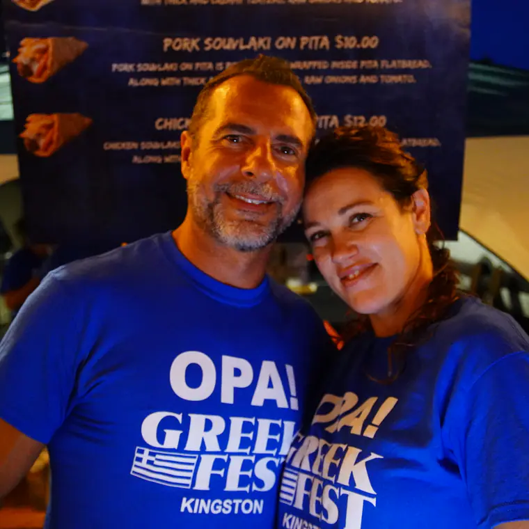 Two guests in OPA! Greek Fest shirts enjoying the evening celebration